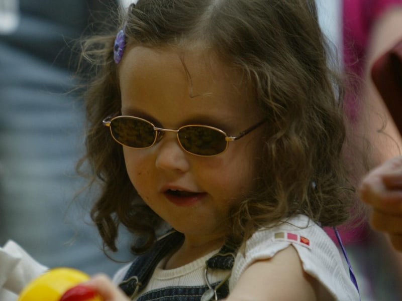 3 year old Courtney Deans catchs a chick at one of the stalls during the carnival. (0107JB55)