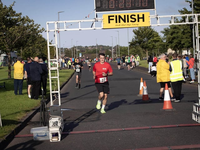 Peter Griffin (27) makes his way across the finish line during Friday evening's Galliagh Feile 5k. (Photos: Jim McCafferty Photography)