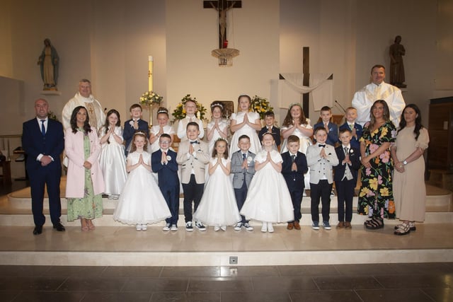 FIRST HOLY COMMUNION . . . . .Pupils from Mr. David O’Donnell’s P4 class at Holy Child PS, Creggan who received the Sacrament of First Holy Communion from Fr. Ignacy and Fr. McFaul at St. Mary's Church on Sunday morning last. Included are Ms. Pat Concannon, Principal (left), Aimee Black and Shannon Moran, Classroom Assistants. (Photos: Jim McCafferty Photography)