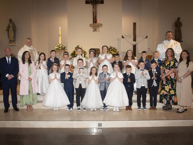 FIRST HOLY COMMUNION . . . . .Pupils from Mr. David O’Donnell’s P4 class at Holy Child PS, Creggan who received the Sacrament of First Holy Communion from Fr. Ignacy and Fr. McFaul at St. Mary's Church on Sunday morning last. Included are Ms. Pat Concannon, Principal (left), Aimee Black and Shannon Moran, Classroom Assistants. (Photos: Jim McCafferty Photography)