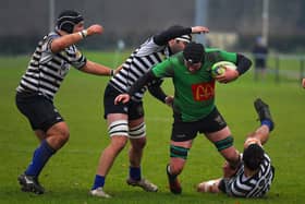 City of Derry’s Tiarnan Dillon is hauled to the ground during Saturday’s game against CIYMS. Photo: George Sweeney