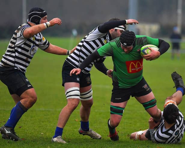 City of Derry’s Tiarnan Dillon is hauled to the ground during Saturday’s game against CIYMS. Photo: George Sweeney