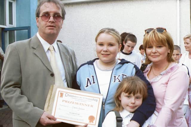 Richard Moore, Director of Children in Crossfire, pictured with Niamh Graham, a prizewinner in the writing competition. Also in photograph are Shauna and Linda Graham. 260603HG2