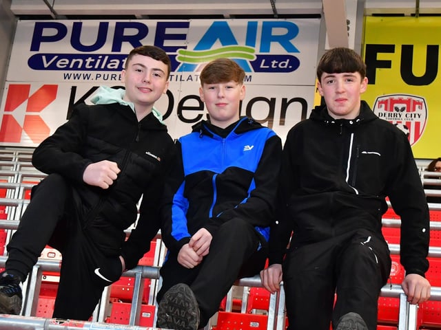 Three Derry City fans looking confident before kick-off.