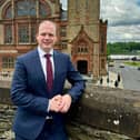 Minister Lyons pictured on The Derry Walls.