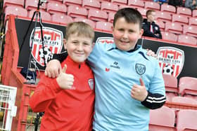 Two young Derry City fans give thumbs up to our cameraman.