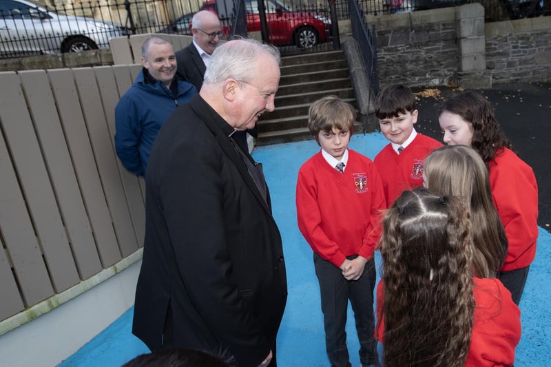 Bishop Donal McKeown talks to a group of children about the new playground on Monday. Included at back are Kieran Phelan, Board of Governors and Gerry Gallagher, former Board of Governors.