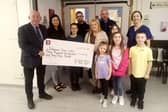 The family of John Coyle handing over £3,143.00 to Sister Cathy O'Donnell at the Intensive Care Unit (ICU) at Altnagelvin Hospital.