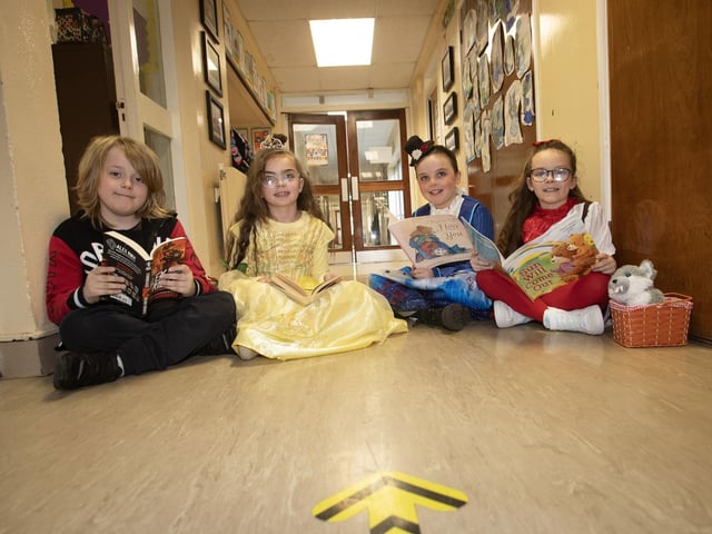 Primary 4 pupils at St. Brigid's PS enjoying some reading in the corridor on Thursday.