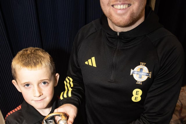 Young Logan McCourt, Phoenix FC receiving the U8s Player of the Year award from Ronan O'Donnell.