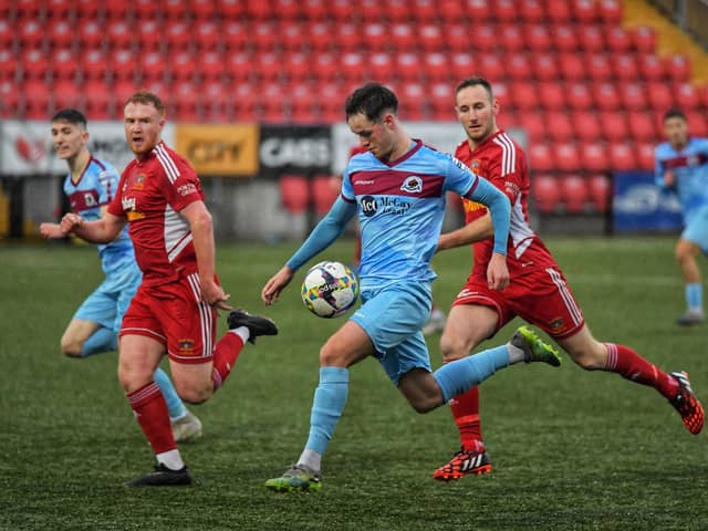Institute's Michael Harris is chased by Annagh United pair Lee Upton and Scott McCollough. Photo: George Sweeney