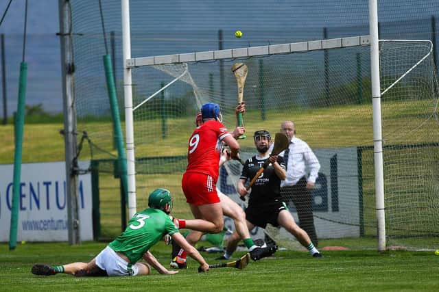 Meehaul McGrath scores a point for Derry against London. Photo: George Sweeney