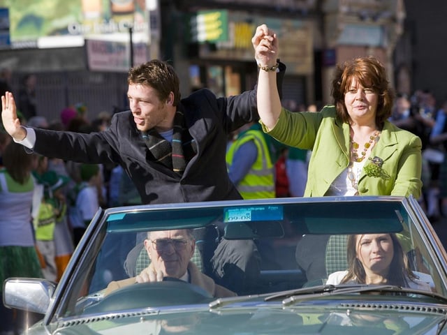 Derry's professional boxer John Duddy with Deputy Mayor Patricia Logue salutes the thousands of people who lined the route of the St. Patrick's Day Parade