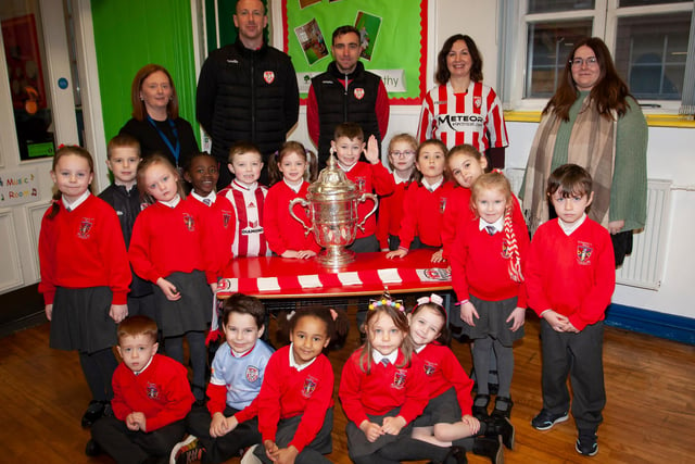P2 pupils at St. Eugene’s PS show their support for Derry City on Monday last as players Shane McEleney and Joe Thompson brought the FAI Cup to the school.