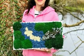 Tetiana Dukhno with her creation based on the Culdaff River.