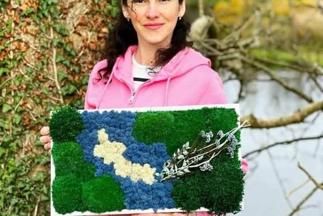 Tetiana Dukhno with her creation based on the Culdaff River.