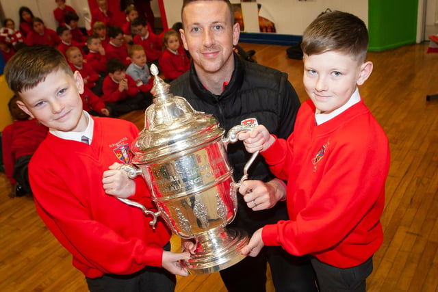 Twins Brandon and Tiernan Page pictured with Shane McEleney and the FAI Cup on Monday.