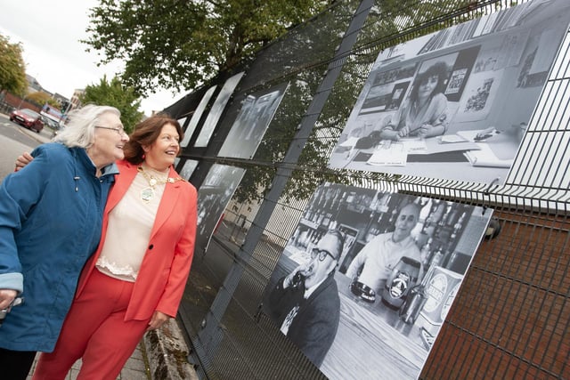 Well known community activist Mary Nelis pictured with the city and district's Mayor, Patricia Logue, looking at a photo of her 'younger self' in Friday's photo exhibition at Pilot's Row.