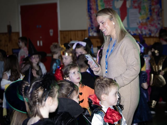 Mrs O'Donnell videos some groovy moves at the P1 and 2 disco at Hollybush PS on Wednesday. : .