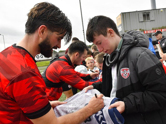 Brandon Fleming signs a shirt for a fan at the Derry City open training session on Monday morning in Brandywell Stadium. The event was organised at part of the Gasyard Feile. Photo: George Sweeney / Derry Journal