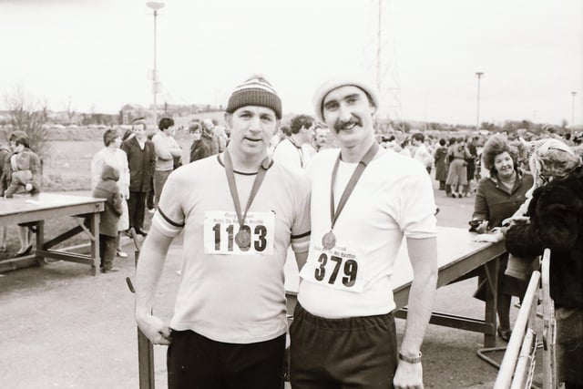 These two participants proudly show off their medals after completing the Male Mini Marathon in December 1983.