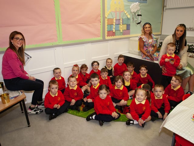 Mrs. Rachel O'Donnell pictured with her P1 class at Steelstown PS this week. On left is Melissa Donnelly, and right, Miss Caitlin Browne, Classroom Assistants. (Photos: Jim McCafferty Photography):.