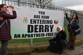 Nadya Tannous, left, Yasmine El Souda and Nihal El Ansar representing  the Palestine Youth Movement launch a sign “You are now entering Derry an apartheid free zone” erected by the Bloody Sunday Trust, at the Junction of Letterkenny Road and Lone Moor Road, as part of this year’s Bloody Sunday anniversary events. Photo: George Sweeney