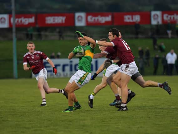 Glen ‘s Michael Warnock hold possession under pressure from Slaughtneil’s Cormac O’Doherty and Paul McNeill during Sunday’s SFC semi-final at Owenbeg. Photo: George Sweeney