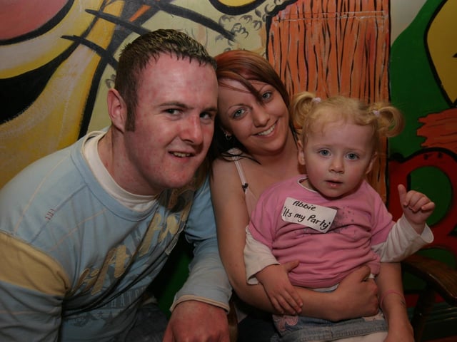 Abbie pictured with her mum Tina and dad Danny as she celebrates her 2nd birthday at Bananas 0003/JML : Parties and celebrations January 2006: Abbie Simpson.