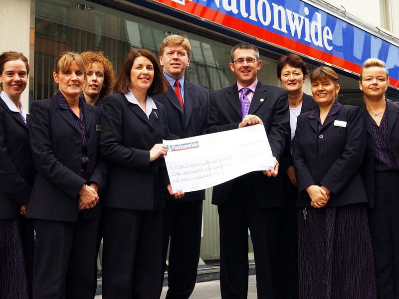 Staff from Nationwide Building Society presenting a cheque for £1,686.42 to Paul Sweeney, MacMillan Cancer Relief. Included, from left, Valerie Thompson, Maria O'Donnell, Maeve McLaughlin, Karen Carolan, Peter Corr, Sheila Murray, Elaine McCracken and Roslyn Barrett.