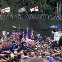 DRUMCREE, UNITED KINGDOM - JULY 9:  Loyalist Orangemen hold their rally in front of the British military's blockade of the road past the Drumcree Parish Church in Drumcree 09 July 2000. The marchers went to the military  blockade of the street leading to Garvaghy Road and did not pass into the adjoining Catholic neighbourhood.   (ELECTRONIC IMAGE)  (Photo credit should read JONATHAN UTZ/AFP via Getty Images)