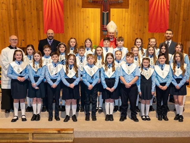 Pictured are pupils from Hollybush Primary School, who made their Confirmations recently. The pupils are pictured with staff and local clergy who officiated at the ceremony.