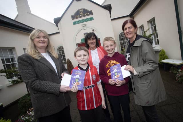 Pupils from Long Tower Primary school pictured receiving their prizes for getting their stories and poetry published in 'Scary Derry'. Receiving their awards from Nora McGowan and Elaine Doherty, Feile Derry, are Daire Anderson and Volodymyr Vorona. Back centre is Mrs. Joyce Logue, Principal. (Photos: Jim McCafferty Photography)