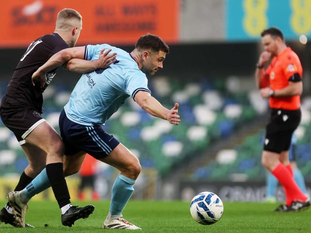 Ardmore's Oran Armstrong puts pressure on his Enniskillen opponent during Friday's fonaCAB Craig Stanfield Irish Junior Cup final at Windsor Park. (Photo: IFA)