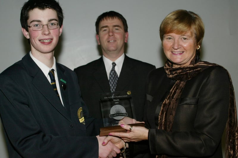 Lorcan Doherty who achieved 1st place in NI in his GCSE music exams pictured here receiving his award from Marian Machett, Chief INspector DENI.  Included in photo is Mr Stephen Gallagher, Head of Key Stage 4.  (1001JB30)