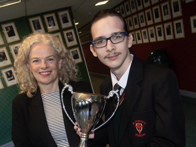 St. Joseph's Boys School Vice Principal, Mrs Harrigan-Stewart presents the Art Prize to Kalum McBride.