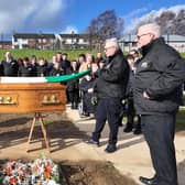 Gearóid Ó hEára, on left, with members of Tony Hassan's family and local republicans at the former councillor's graveside on Wednesday.