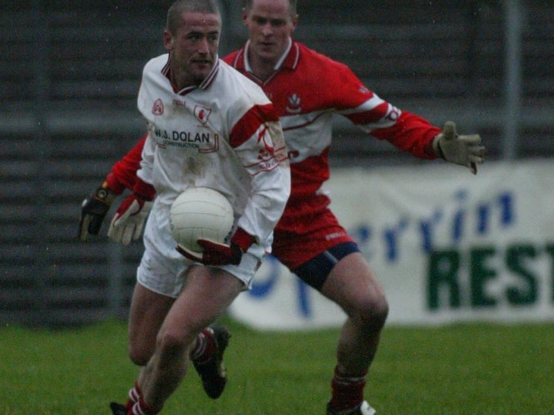 Derry's Kevin McCloy shadows Tyrone forward Stephen O'Neill during the January 2004 Healy Park McKenna Cup match.