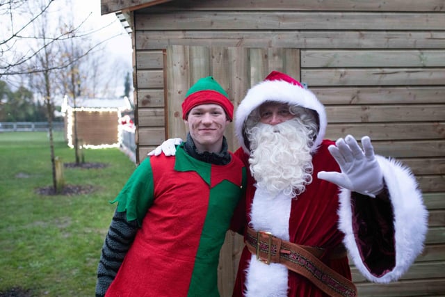 A wave from Santa and his elf.