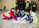 Leaders and consultants, builders and young Beavers, Cubs and Scouts all having a look at the building and the plans.