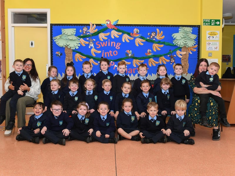Mrs White, teacher, (on the right) and classroom assistant Ms McDaid with their P1 class at Hollybush Primary School.