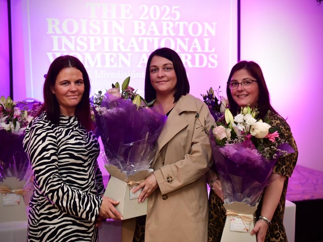 Shauna Gill and Megan Nicell receiving the presentation from Aine Doherty, daughter of Roisin Barton.
