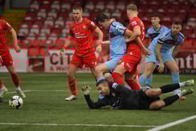 Portadown'S Christopher Rodgers grapples with Institute’s Shaun Leppard during a goalmouth scramble.  Photo: George Sweeney