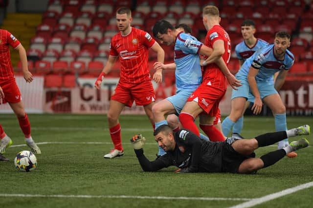 Portadown'S Christopher Rodgers grapples with Institute’s Shaun Leppard during a goalmouth scramble.  Photo: George Sweeney