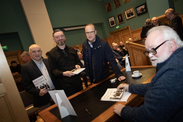 Pat signing books for Francis Callaghan and former Derry Journal colleagues Eugene Duffy and Michael Wilson.