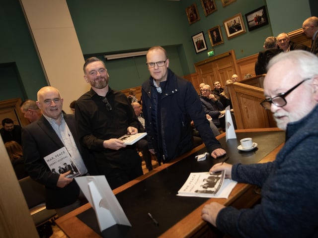 Pat signing books for Francis Callaghan and former Derry Journal colleagues Eugene Duffy and Michael Wilson.