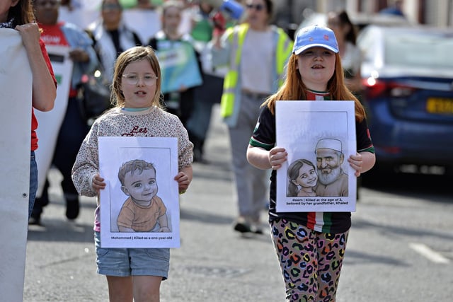 Young girls carry sketches of murdered Palestinian children Mohammed, aged one and Reem, aged three, at the Freedom for Palestine march and rally held on Saturday afternoon. Photo: George Sweeney