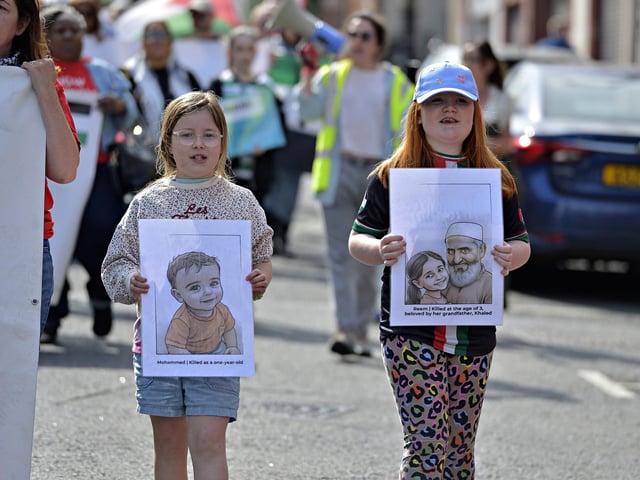 Young girls carry sketches of murdered Palestinian children Mohammed, aged one and Reem, aged three, at the Freedom for Palestine march and rally held on Saturday afternoon. Photo: George Sweeney