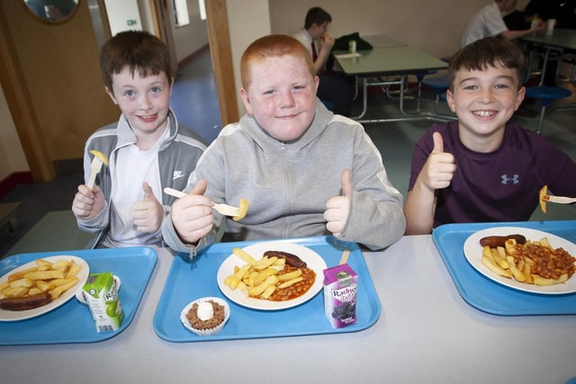 MODEL PUPILS!. . . .Model Primary School pupils Nathan Gibson, Harvey Quigley and Jaydn Doherty tuck into some lunch.