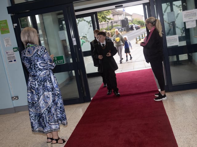 RED CARPET. . . .New Year 8 students make their way through the doors of St. Joseph's Boys School on Monday morning. : St. Joseph's Boys School welcomes latest influx of Year 8 pupils